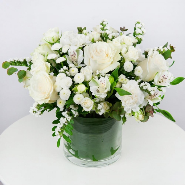 White rose 50 cm - 5, Spray rose: white, cream, light pink 50 cm - 4, Carnation white, cream - 4, Alstromeria white, soft pink - 3, Santini White Spray Chrysanthemum - 4, Transparent vase, Oasis, White statice, Pistachio, Eucalyptus Cinerea