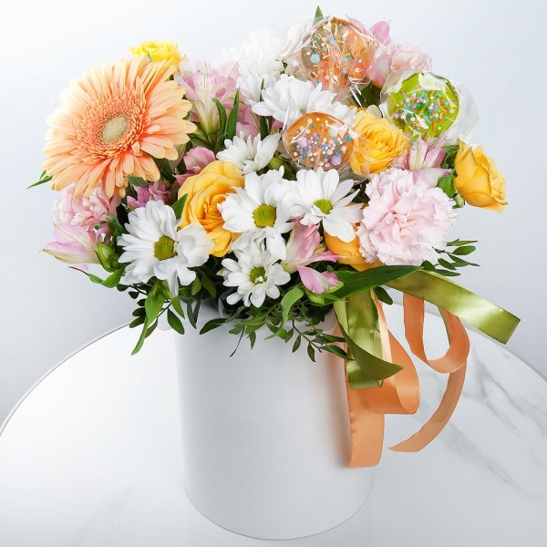 Gerbera yellow - 1, Pink carnation - 5, Alstromeria white, soft pink - 4, Bacardi White Spray Chrysanthemum - 2, Spray rose: yellow, orange 50 cm - 2, Round flower box small , Ribbon, Oasis, Pistachio, Topper (for flowers)
